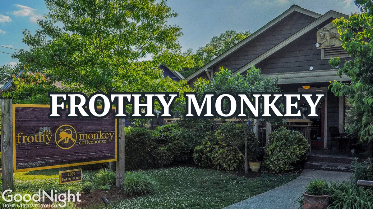 The exterior of Frothy Monkey café features inviting outdoor seating, landscaped greenery, and a welcoming entrance—an ideal spot for socializing over coffee or informal business chats.